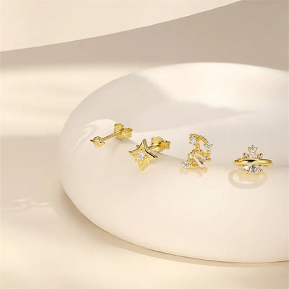925 sterling silver celestial earring set with zirconia star and planet designs displayed against a soft background.