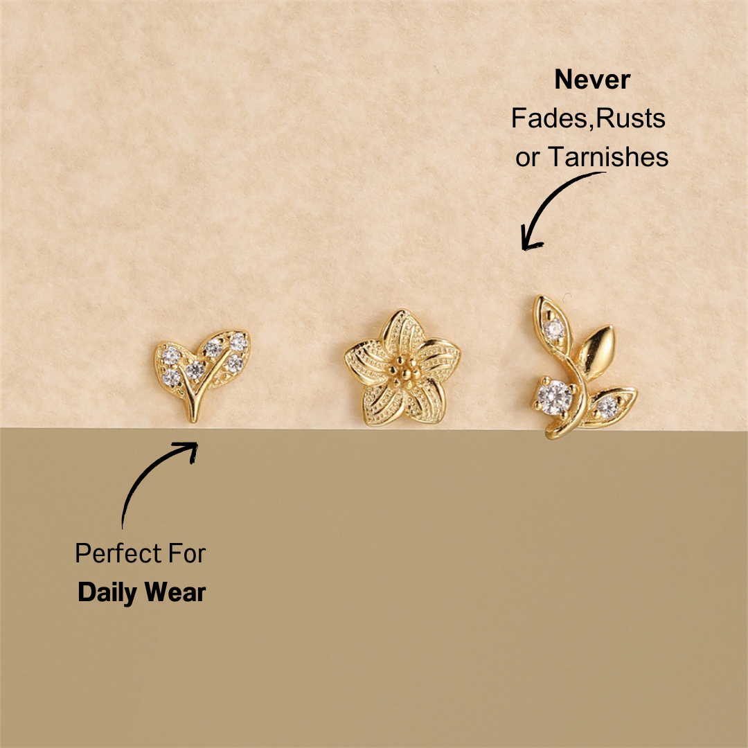 925 sterling silver CZ floral and leaf earrings set with gold-plated finish, arranged on a soft neutral background.