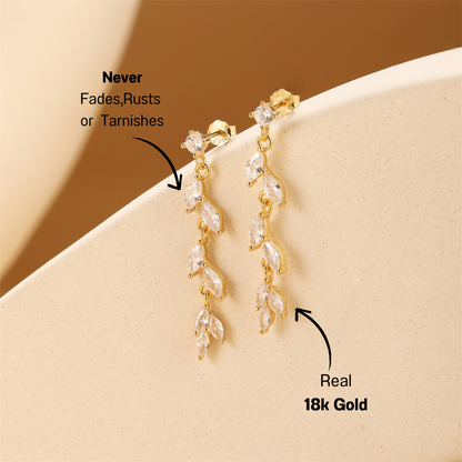 925 sterling silver leaf drop earrings with sparkling zirconia stones displayed on a neutral background for a chic look.