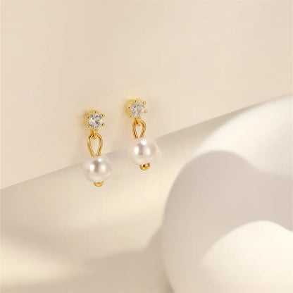  925 sterling silver pearl drop earrings with zirconia accents displayed on a light background, highlighting the classic elegance of the design.