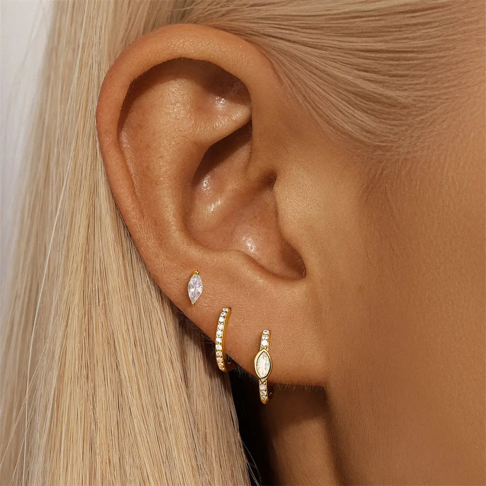 Model showcasing the 925 sterling silver zirconia 3-piece earring set with marquise-shaped stud and gold hoop earrings.