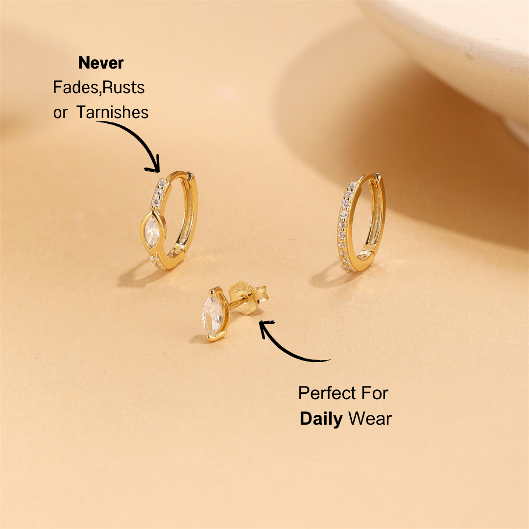 Styled 925 sterling silver zirconia 3-piece earring set with gold hoops and marquise stud against a neutral background.