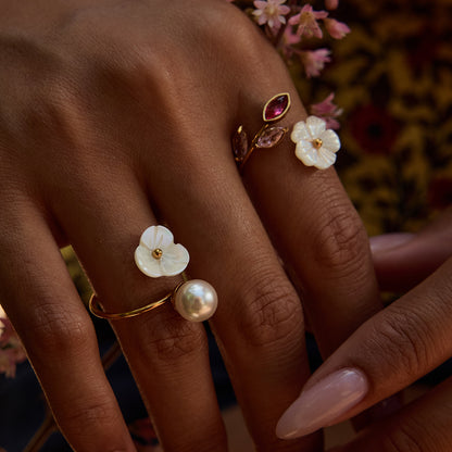 Model wearing pink gemstone floral ring in natural light