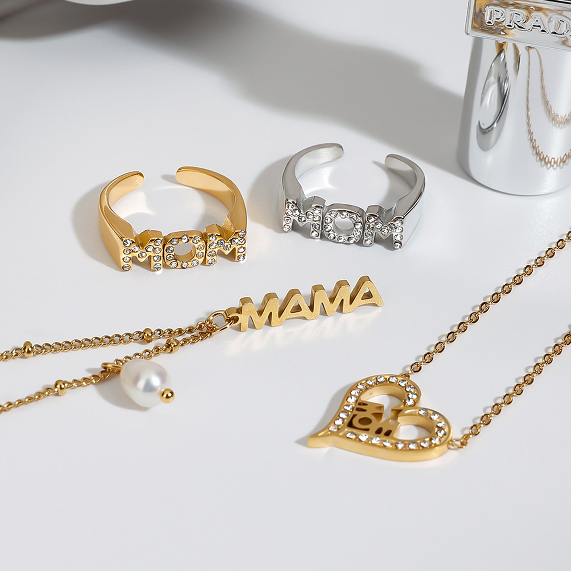 Full view of gold necklace with adjustable chain and dangling MAMA charm and pearl