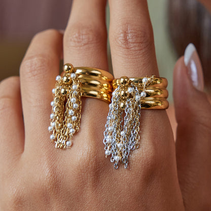 Fashion ring with gold chain tassels on model’s hand
