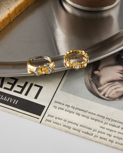 Two gold rings on a newspaper with a blurred background