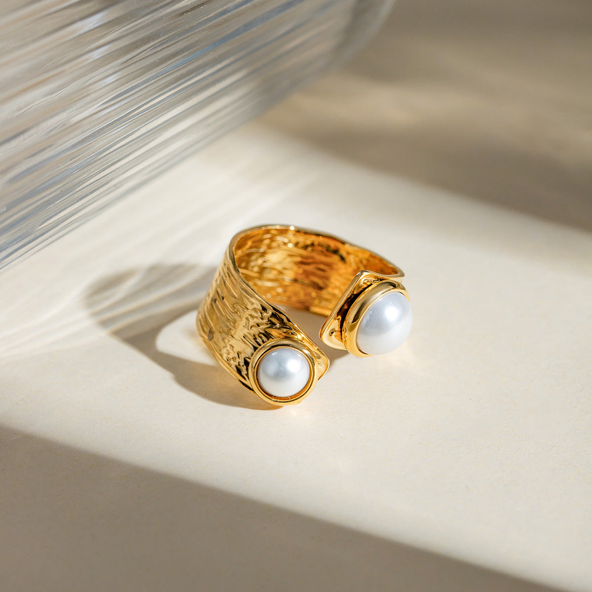 textured gold open ring with pearls placed in natural daylight
