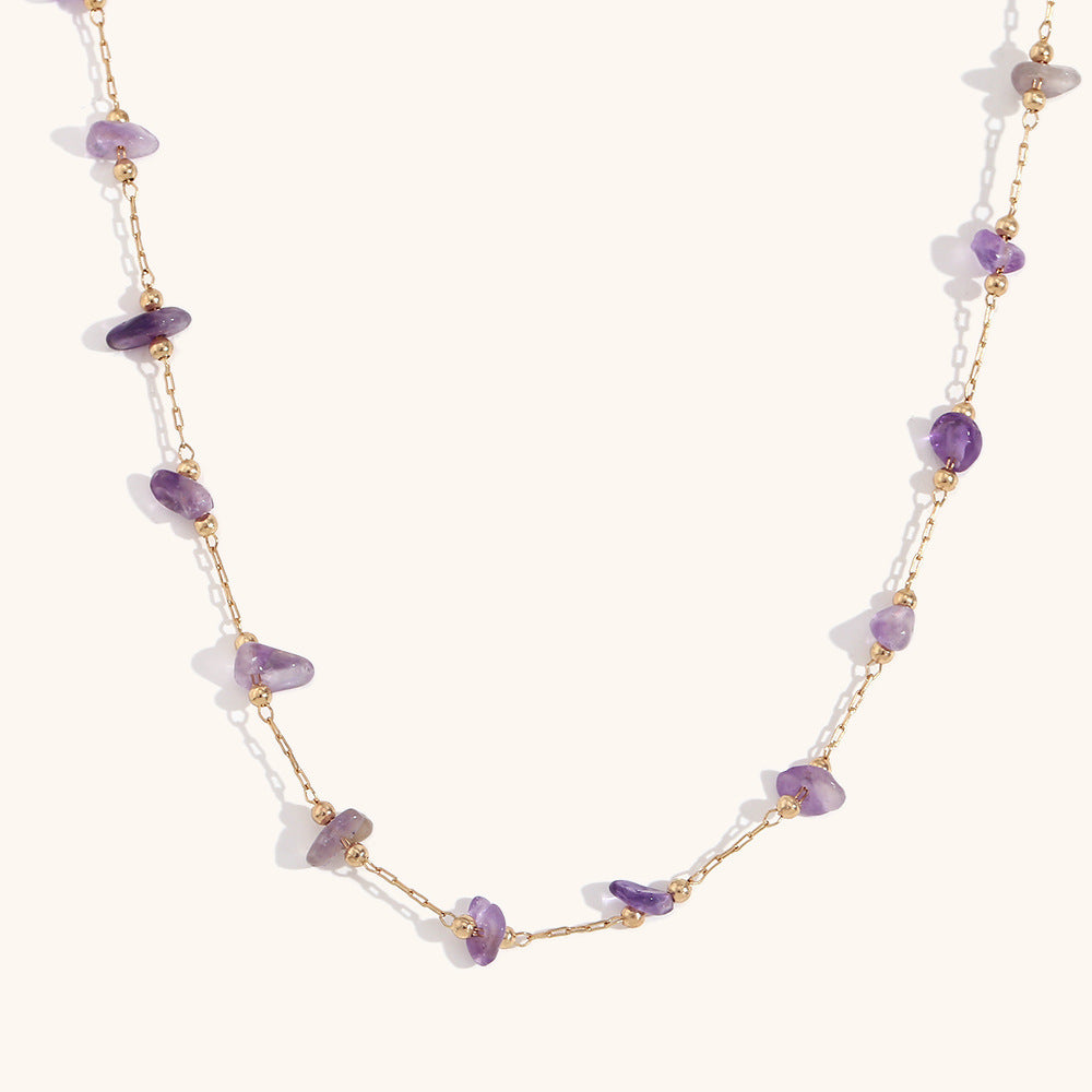 Close-up of amethyst chip necklace layered with matching bracelet