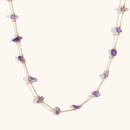 Close-up of amethyst chip necklace layered with matching bracelet