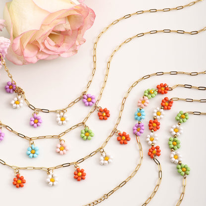 Variety of gold chain necklaces with colorful beaded flower pendants