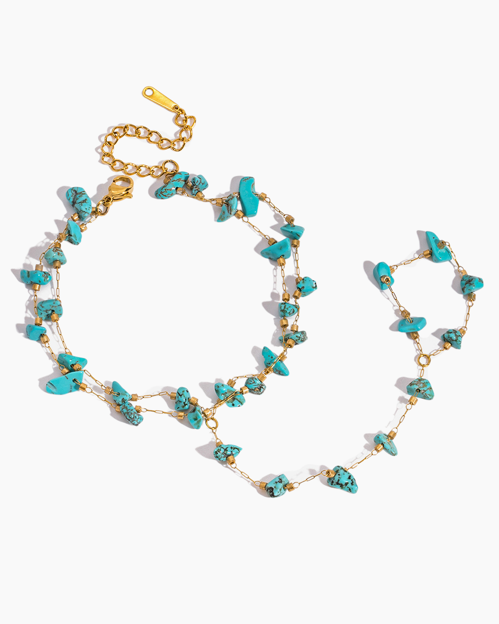 Turquoise and gold necklace on a white background