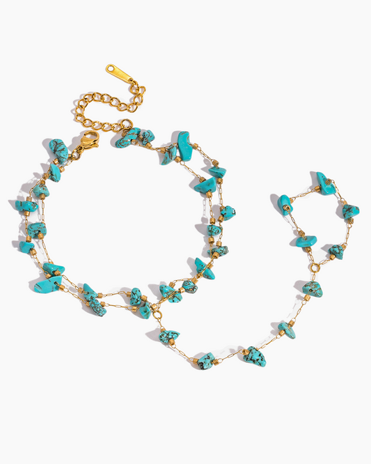 Turquoise and gold necklace on a white background