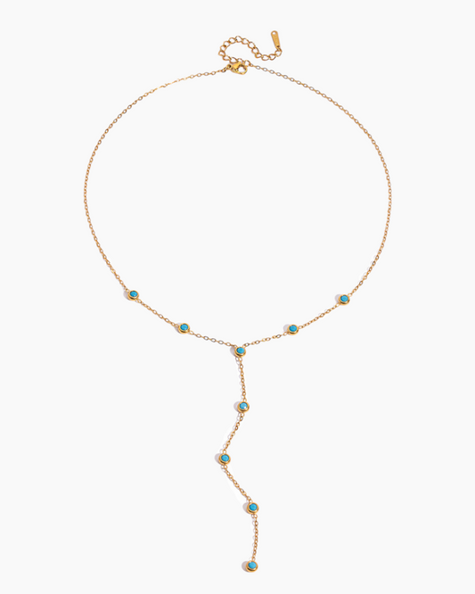 Gold necklace with turquoise stones on a white background