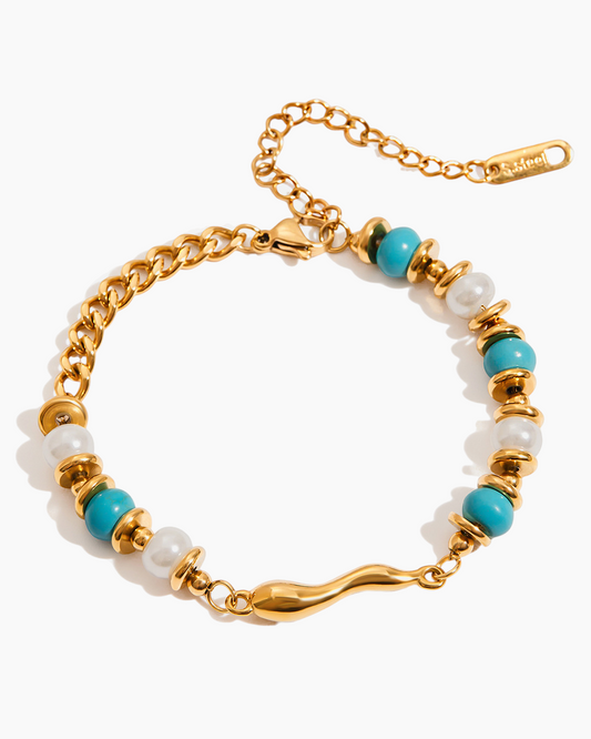 Bracelet with gold chain, turquoise beads, and pearls on a white background