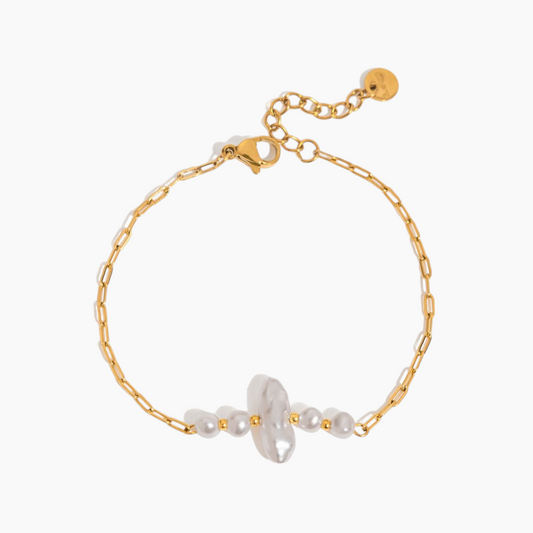Gold bracelet with white beads on a white background