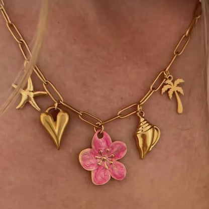 Model wearing tropical charm necklace with white blouse under natural sunlight