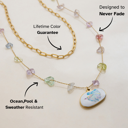Double-layer necklace featuring gold chain and multicolor stones with betta fish pendant