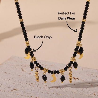 Elegant black crystal and moon charm choker necklace with a sleek background, showcasing the detailed design.