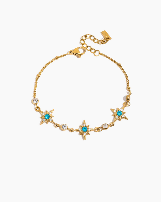 Gold bracelet with star-shaped charms on a white background