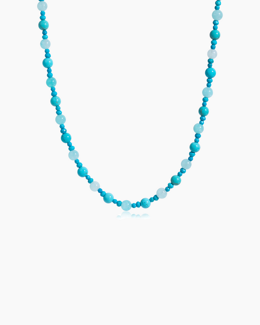 Necklace with blue and white beads on a white background