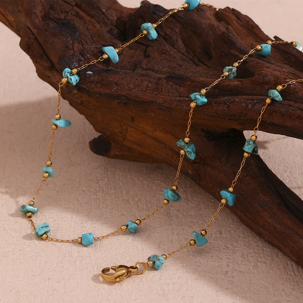 Turquoise necklace elegantly displayed on driftwood