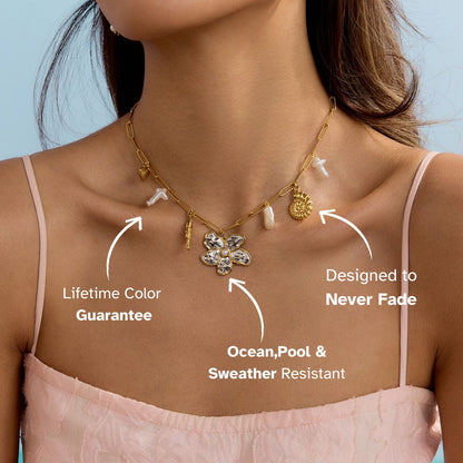 Woman in pink dress wearing layered gold necklace with pearl and mixed pendants – waterproof statement necklace for vacation