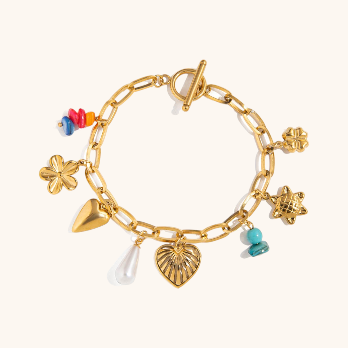 Close-up of stacked gold bracelets with pearls, sunflowers, turquoise and seashells