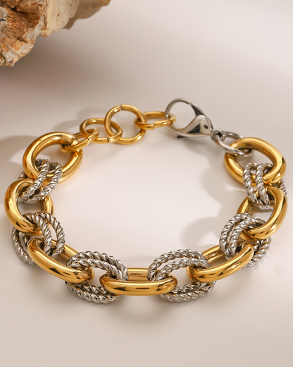 Gold and silver chain bracelet on a light background