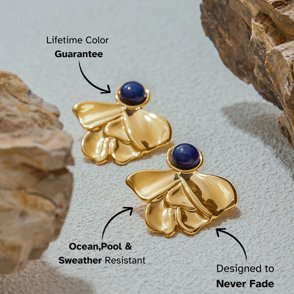Statement gold earrings with lapis gemstone close-up