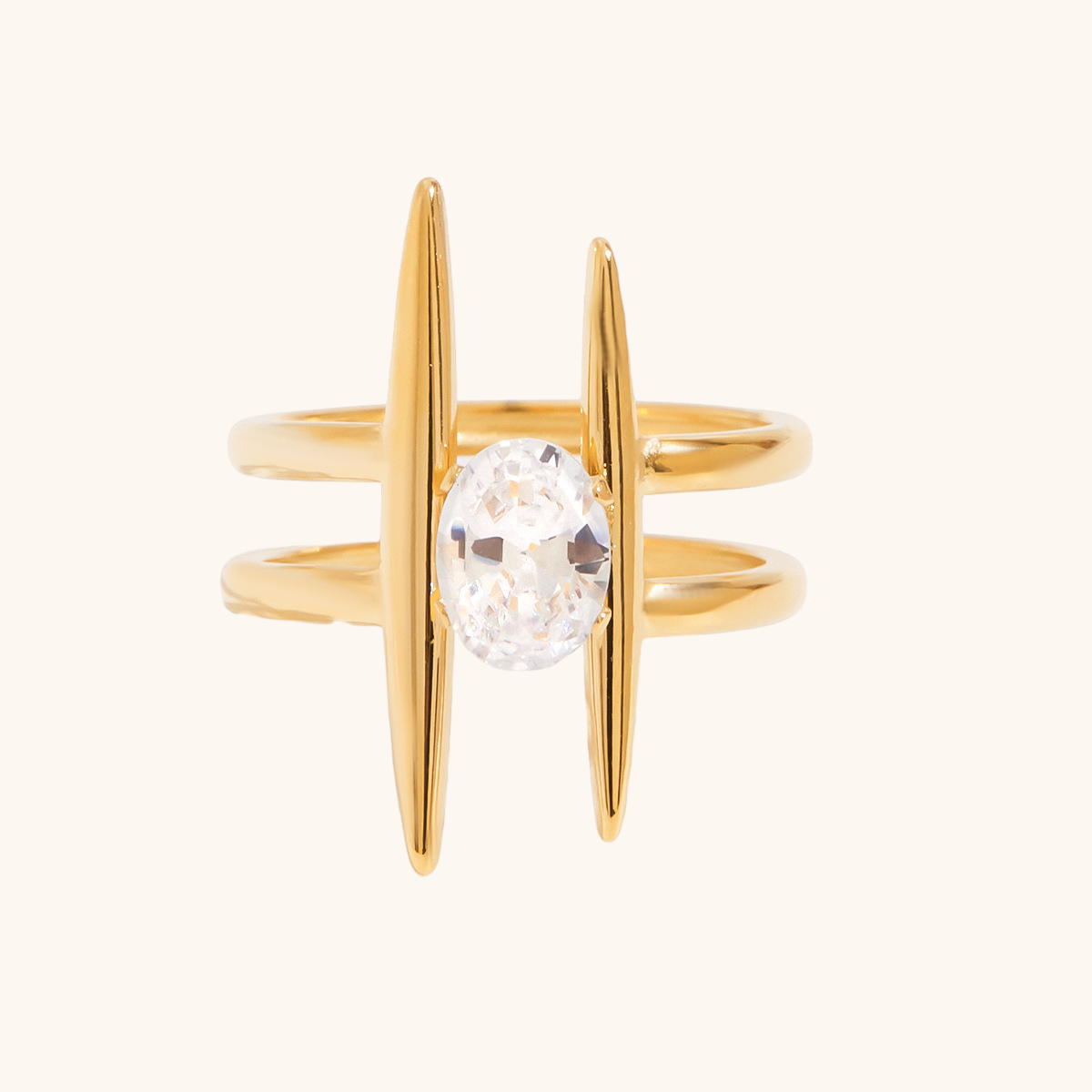Close-up of gold open ring with large oval-cut CZ diamond on white backdrop