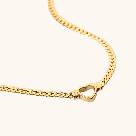 close-up of chunky gold chain with open heart charm