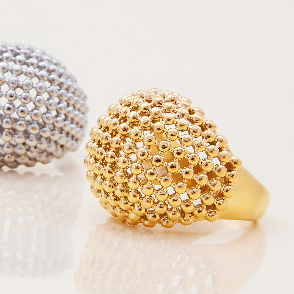 Close-up of textured gold ring with shiny finish