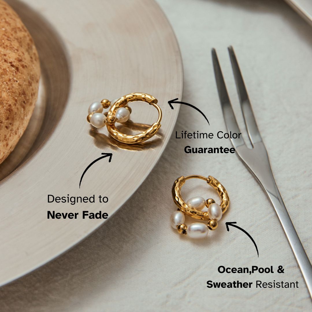 Gold pearl hoop earrings with hammered texture displayed on a silver plate, showcasing their waterproof and fade-proof design.