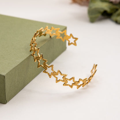 Close-up of waterproof gold bracelet with star cutouts