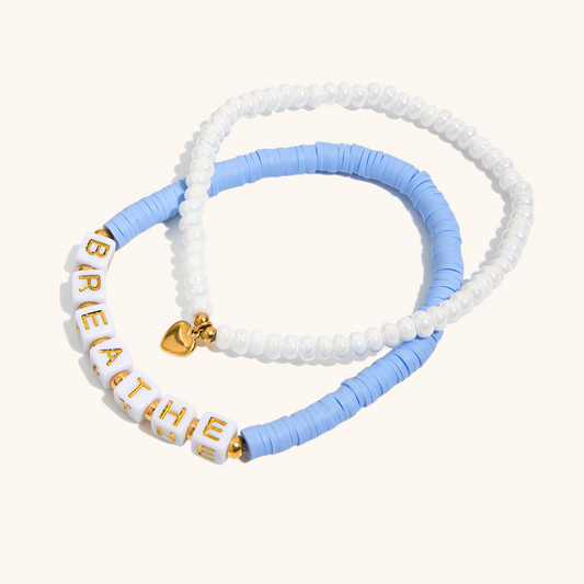 close-up of BREATHE letter bracelet with gold heart charm