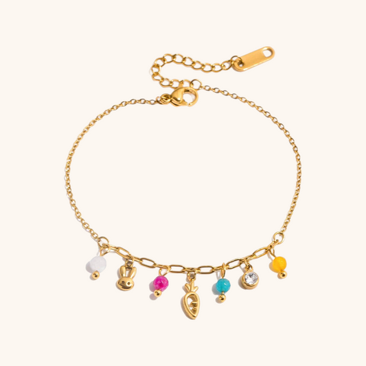 gold link bracelet featuring bunny and carrot pendants