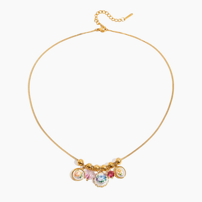 Gold necklace with colorful charms on a white background