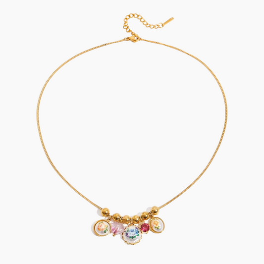 Gold necklace with colorful charms on a white background