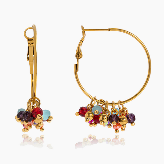 Gold hoop earrings with colorful beads on a white background