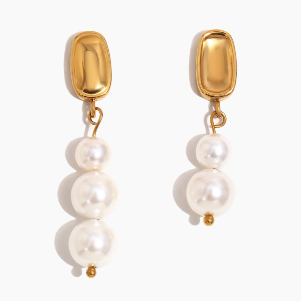Close-up of Celeste pearl drop earrings with gold-plated finish