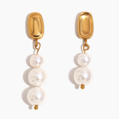 Close-up of Celeste pearl drop earrings with gold-plated finish