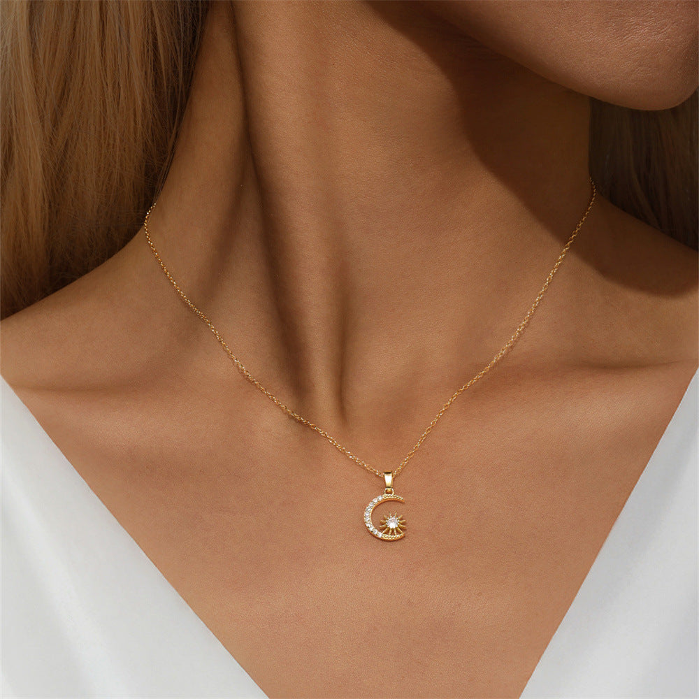 Gold moon and star pendant necklace on model in white outfit, dainty celestial jewelry.