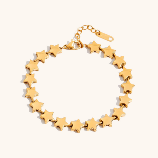 Model wearing celestial gold charm bracelet with star and moon pendants_MiFJewelry