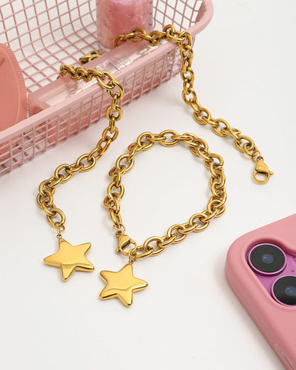 Gold chain with star pendants on a pink phone case and background