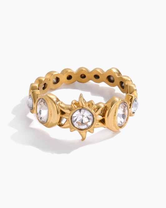 Gold ring with gemstones on a white background