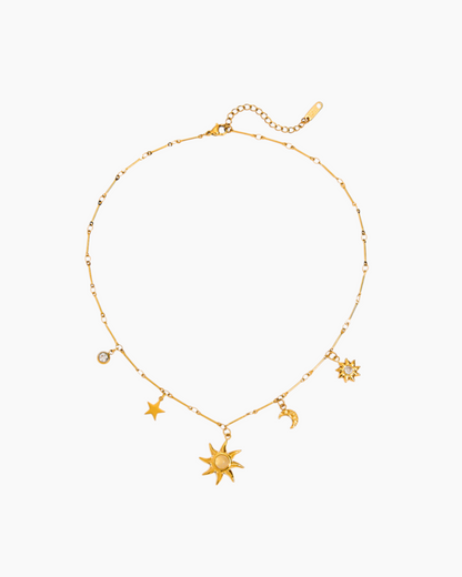 Gold necklace with star and moon charms on a white background