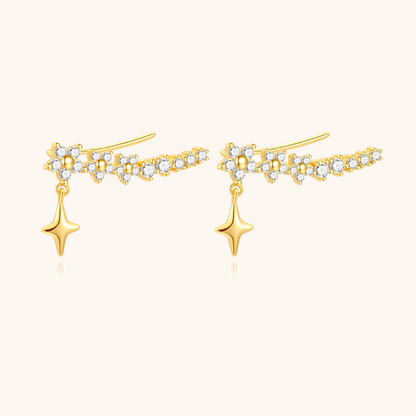 Close-up of gold star drop earrings with zircon stones, perfect for celestial-inspired outfits.