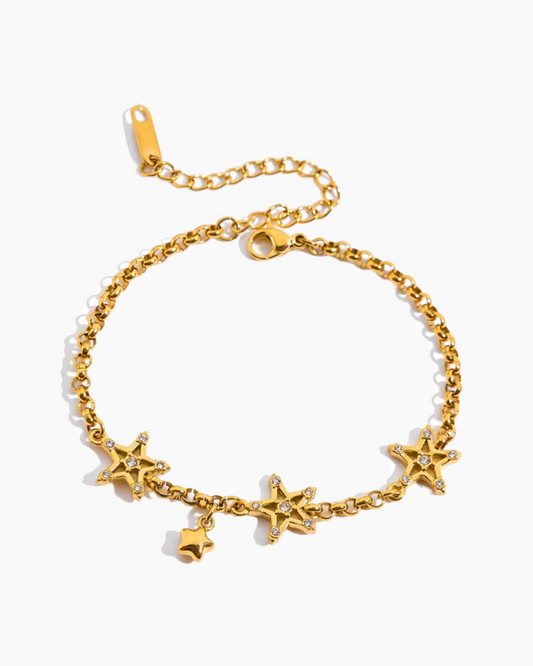 Gold bracelet with star-shaped charms on a white background