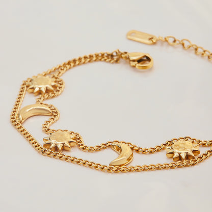 Floating sun and moon charms moving gently on the wrist.