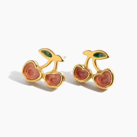 Cherry-shaped earrings with gold and red design on a white background